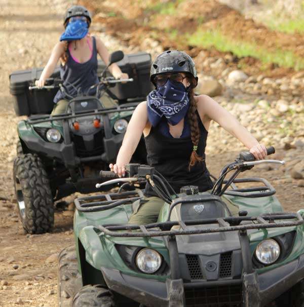 Two girls riding Serendipity ATV's