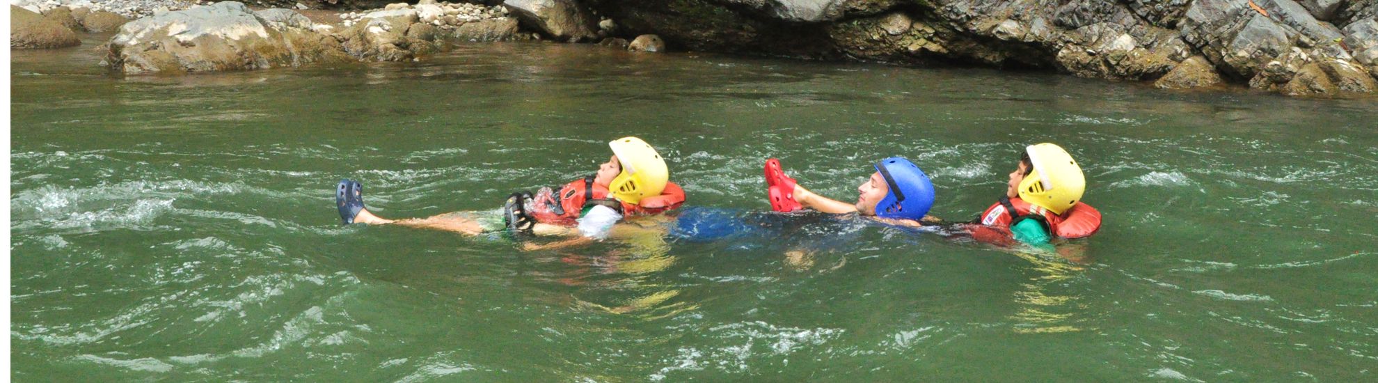 dad and sons chained by feet while floating down the river